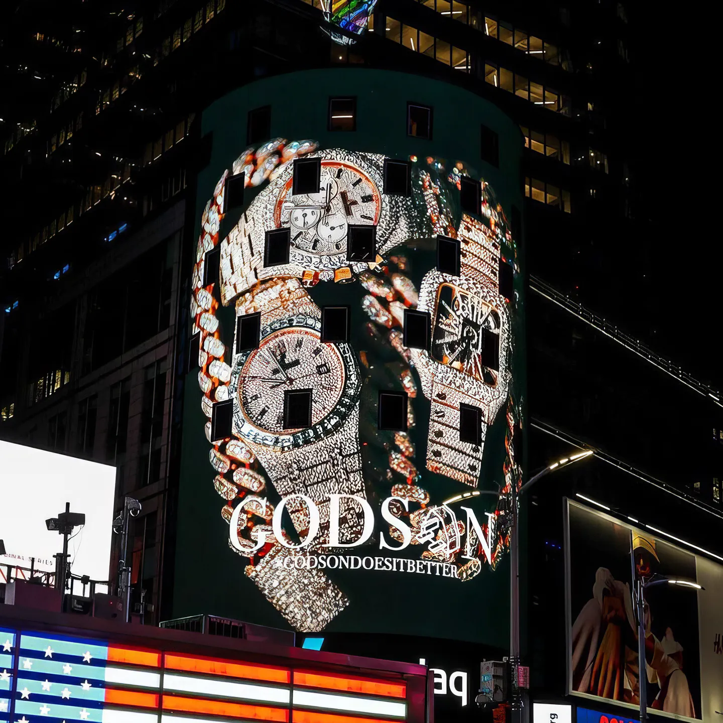 The Godson billboard lit up in Times Square at night