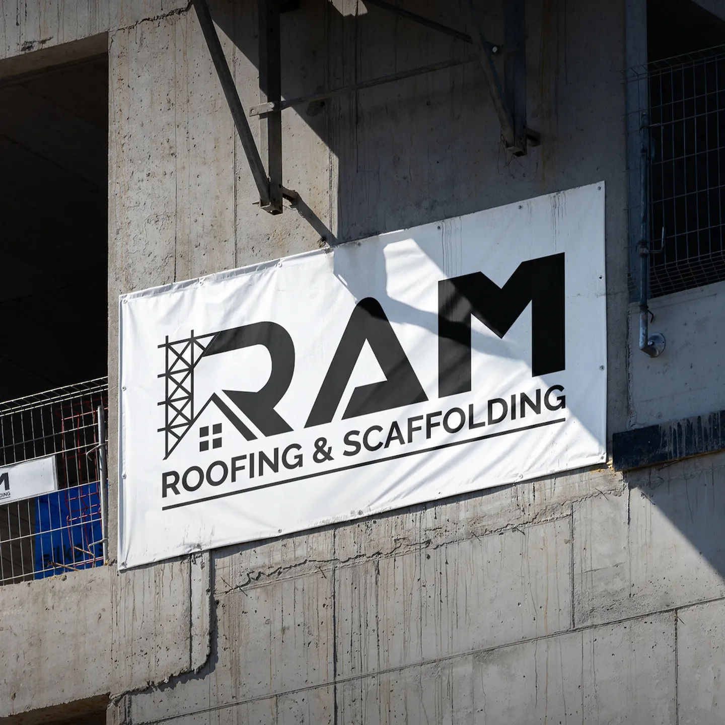 RAM Roofing and Scaffolding banner on a concrete building